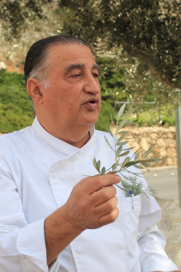 Chef Moshe Basson picks herbs en route to the market